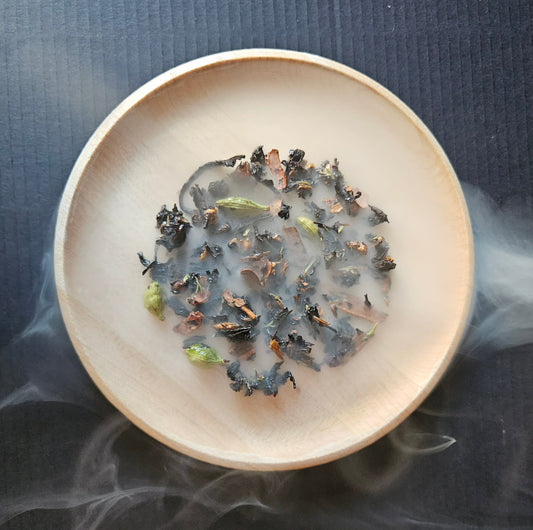Smoked Tartufo Wet Chai in a wooden bowl seen through drifting smoke.