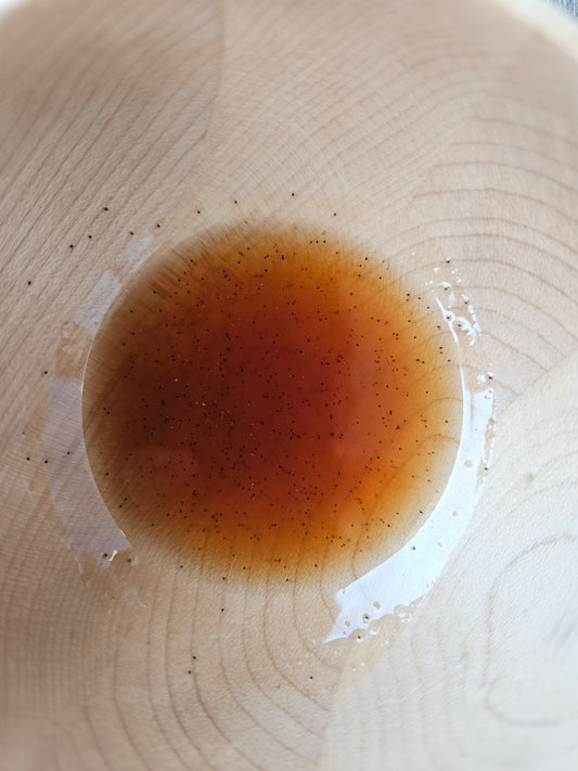 Amber Better Brew concentrate in the bottom of a clear glass.