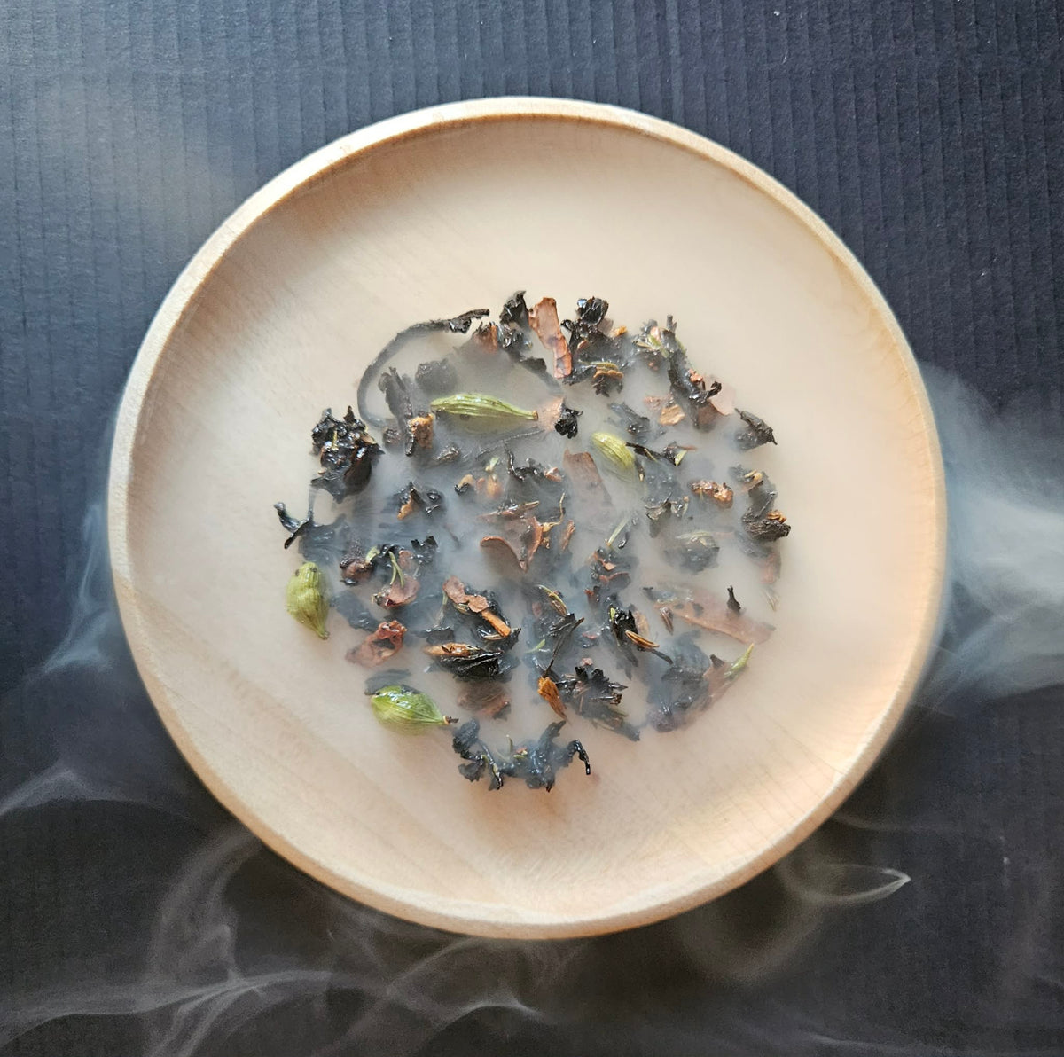 Smoked Tartufo Wet Chai in a wooden bowl seen through drifting smoke.